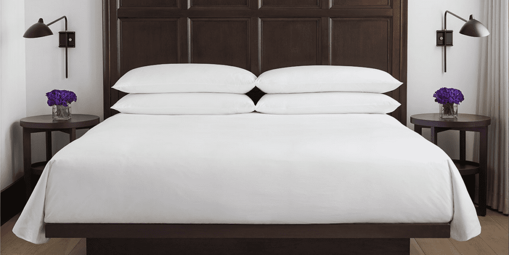 a bed with white sheets