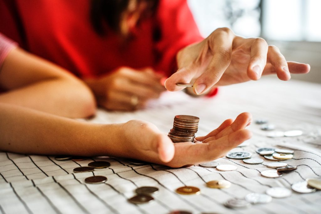 a person holding a coin in their hand