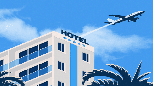 a plane flying over a hotel