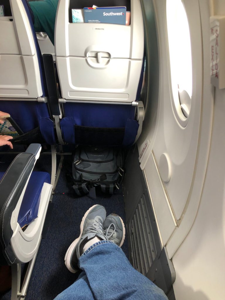 a person's feet in a plane