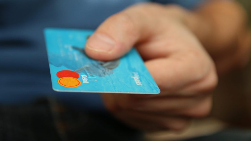 a person holding a credit card