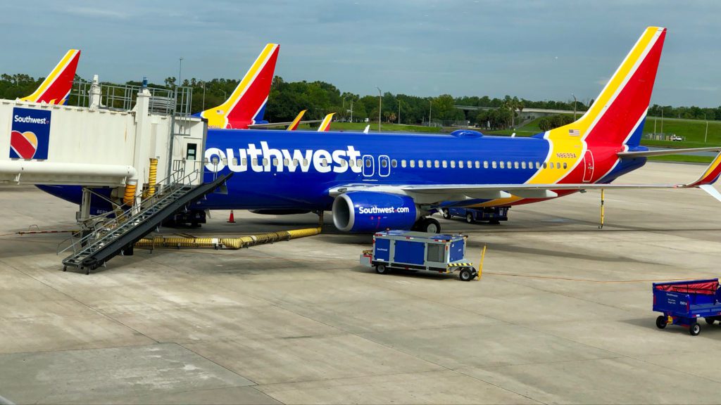 a blue and yellow airplane with a ramp