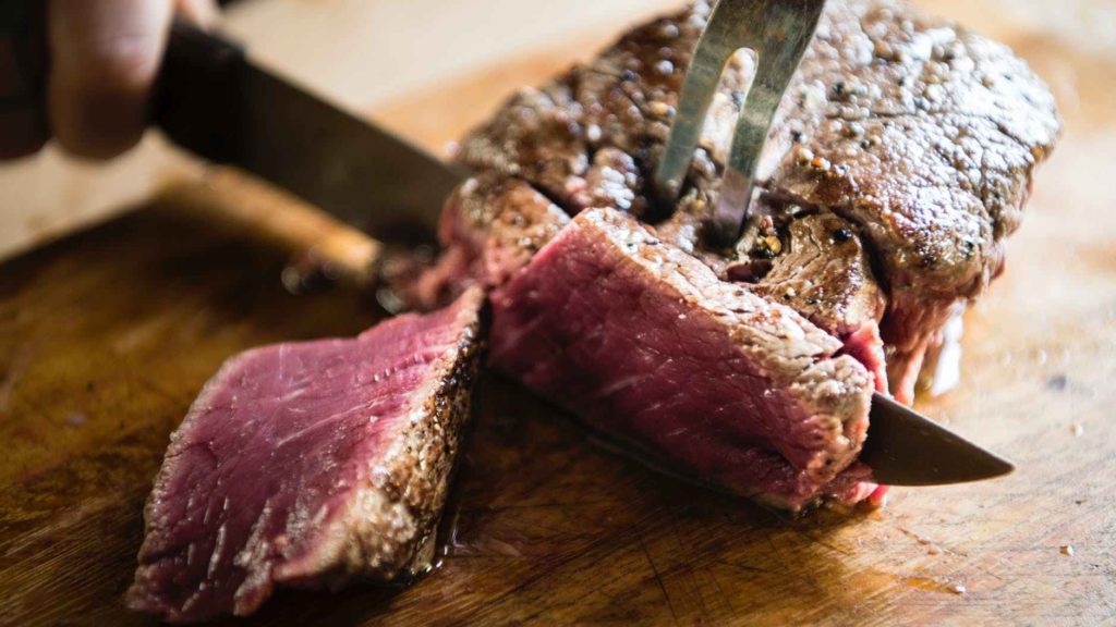 a steak being cut with a fork