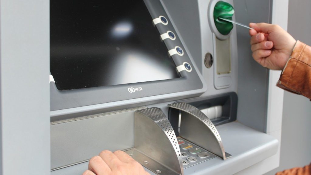 a hand pressing a button on a machine