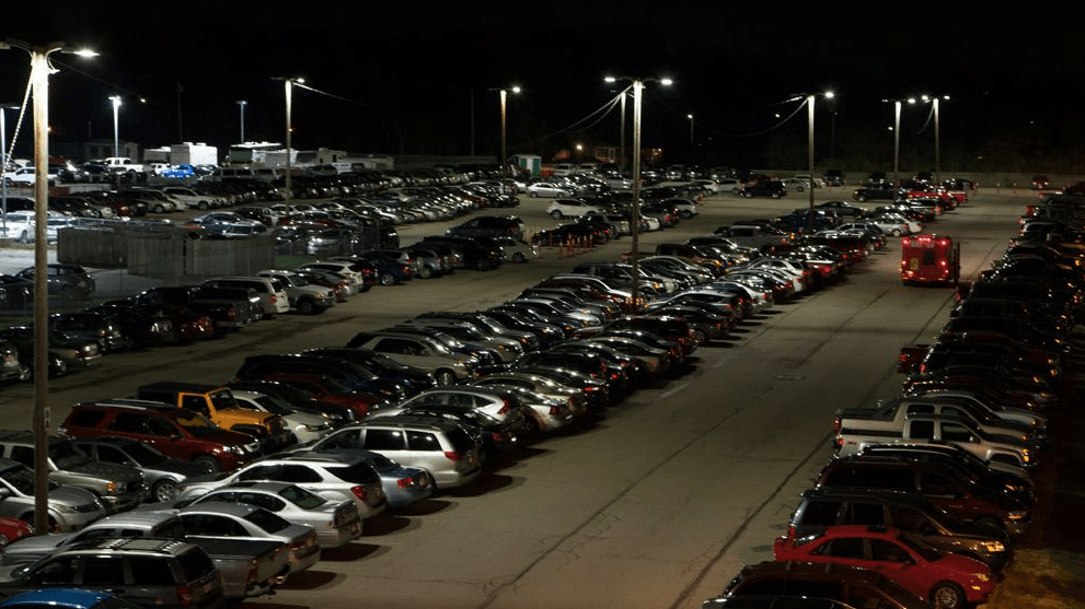 a parking lot full of cars at night