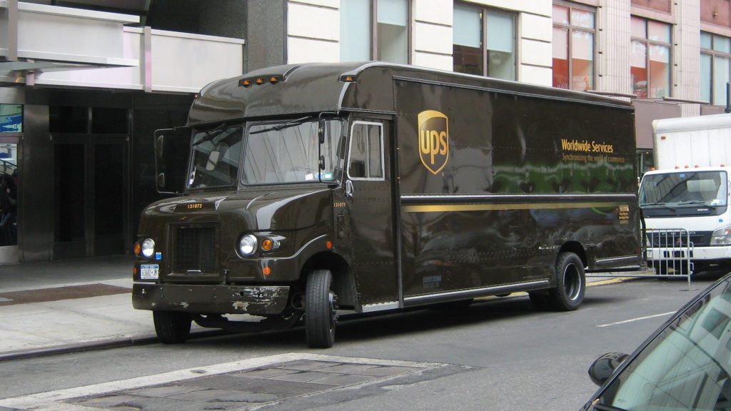 a black delivery truck parked on the street