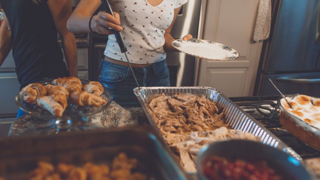 a woman holding a plate and a plate of food