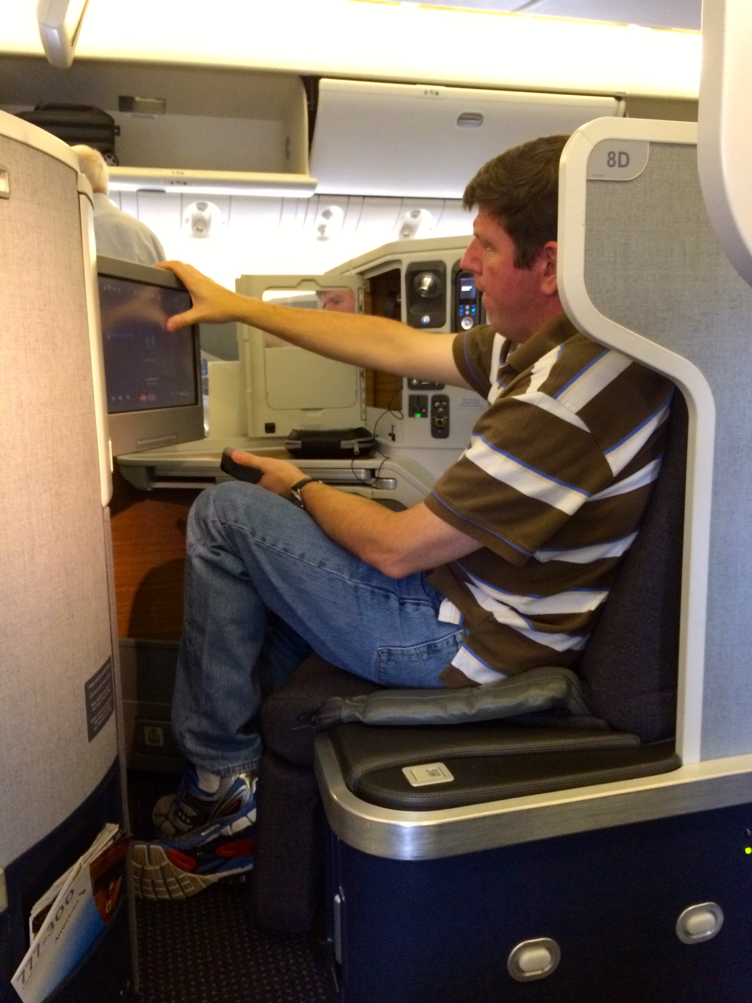 a man sitting in an airplane with a computer