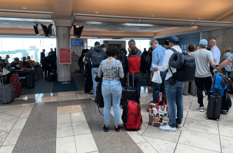 a group of people standing in a line with luggage