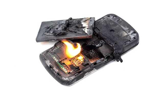 a burnt cell phone with a flame