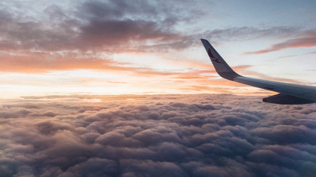 an airplane wing above the clouds