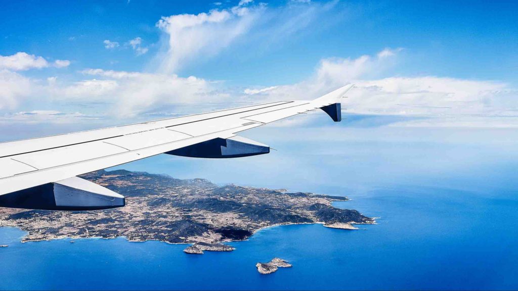 an airplane wing and land and water