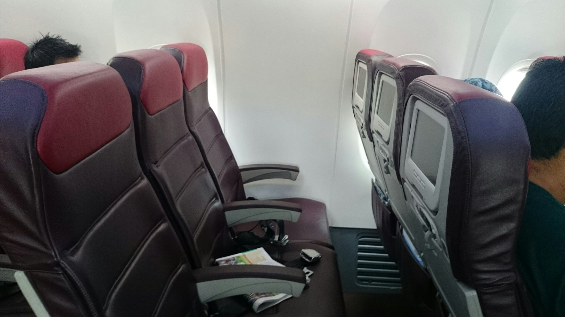 seats in an airplane with a screen on the back