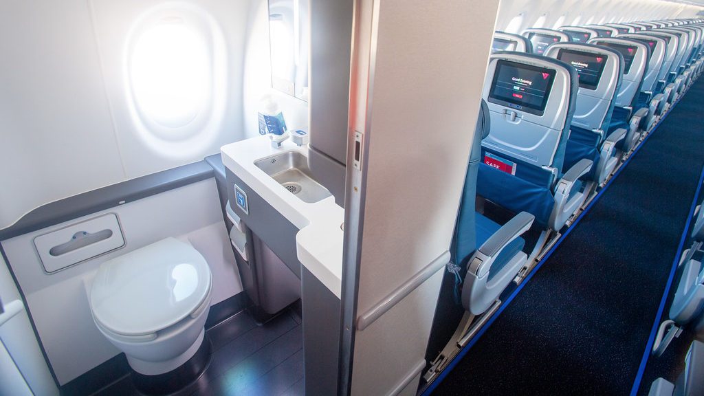 a sink and toilet in an airplane