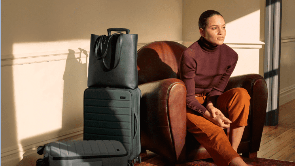 a woman sitting on a couch with luggage