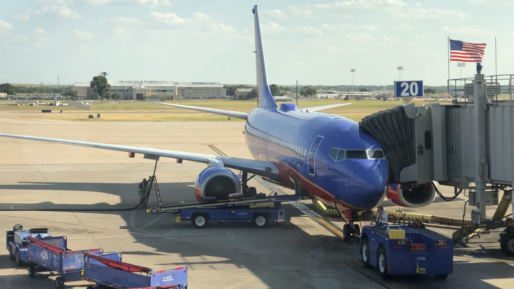 a blue airplane being loaded onto a truck