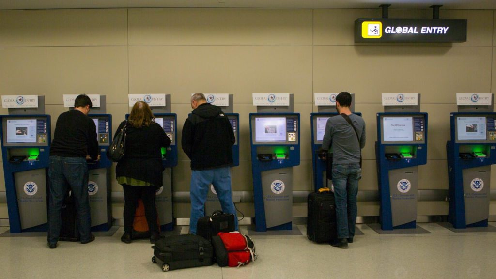 people standing in front of a row of machines