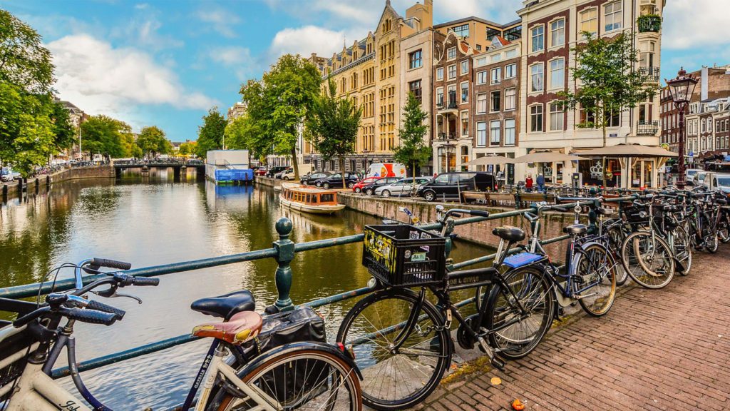 bicycles on a bridge over a canal