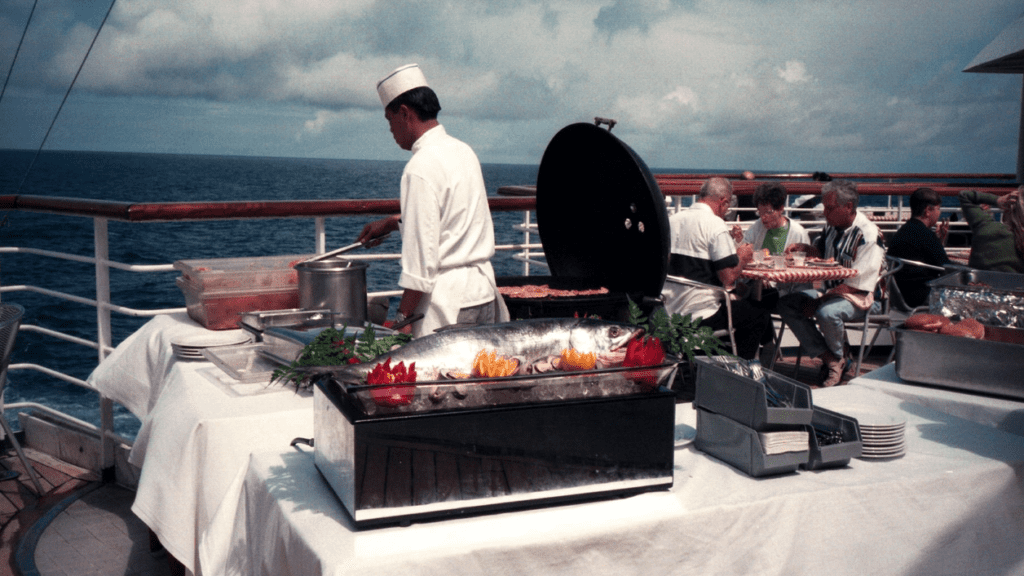 a chef cooking food on a cruise ship