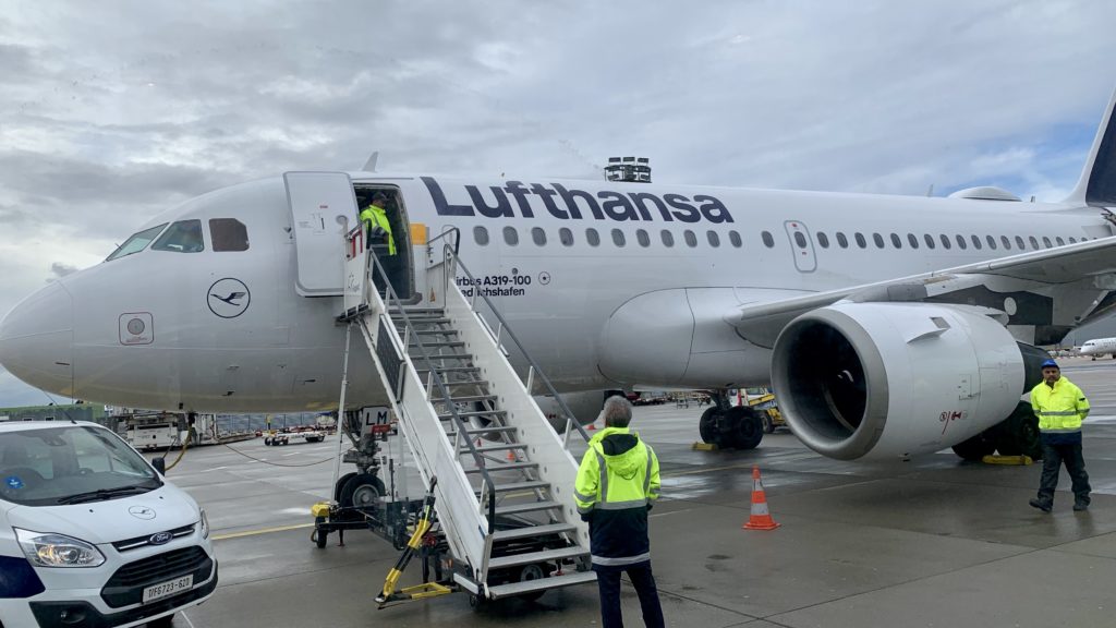 a plane with a ladder and a man standing next to it