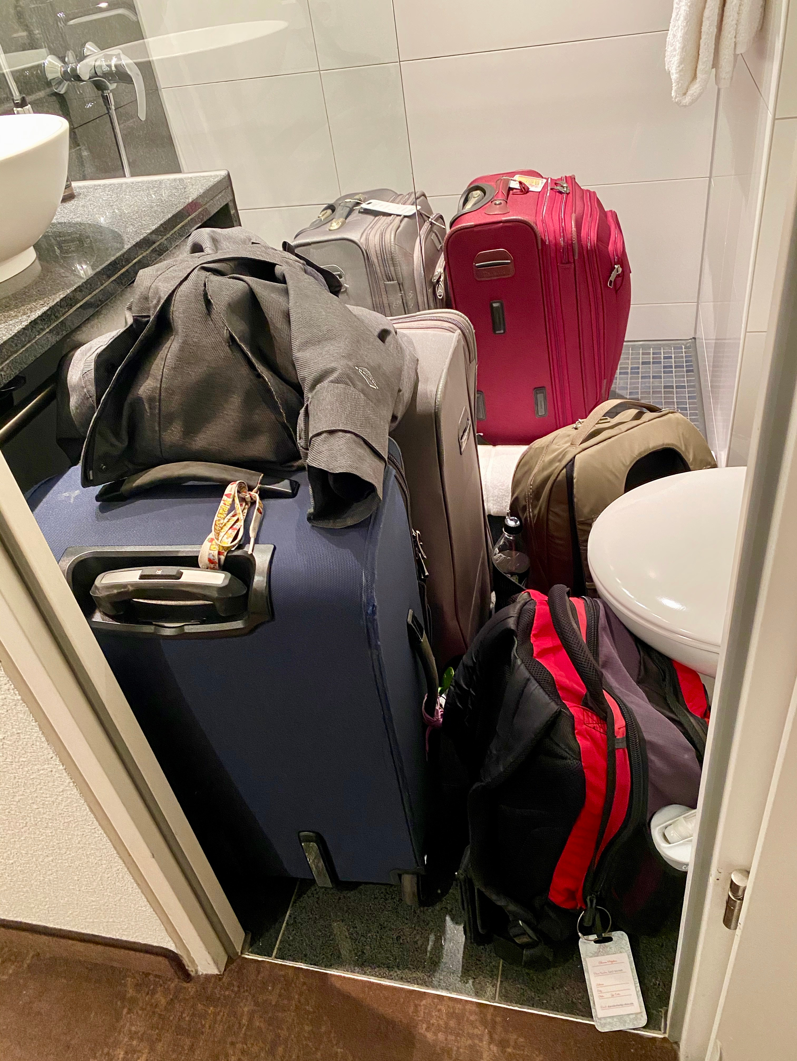 a group of luggage in a bathroom