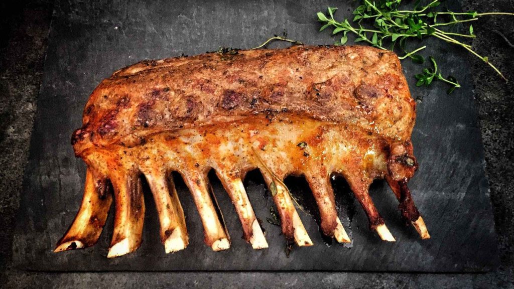 a rack of ribs on a black surface