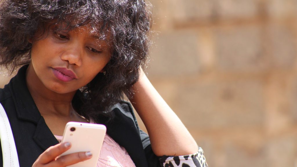 a woman looking at a cellphone