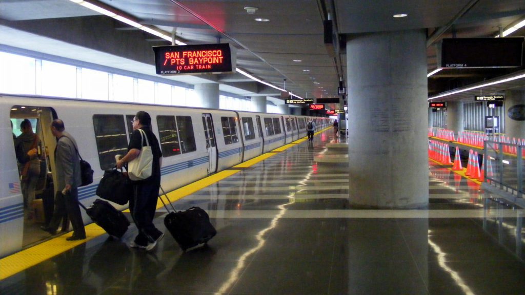 a man pulling luggage in a train station