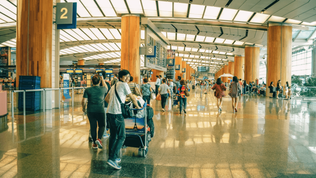 people in an airport with people walking and walking