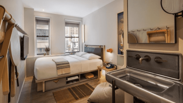 a room with a sink and a bed