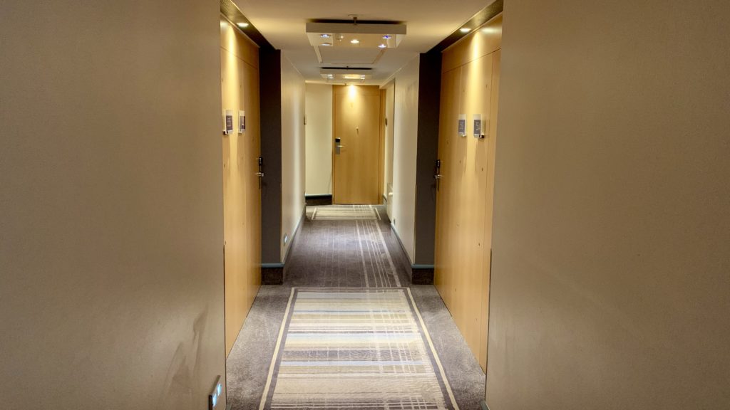 a hallway with doors and carpet