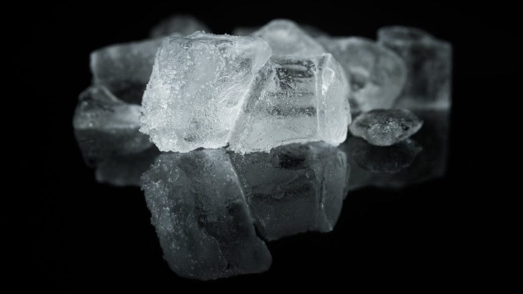 a group of ice cubes on a black surface