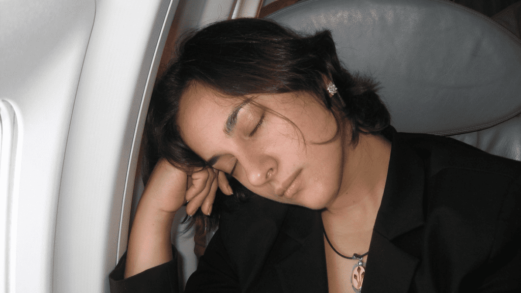 a woman sleeping on a plane