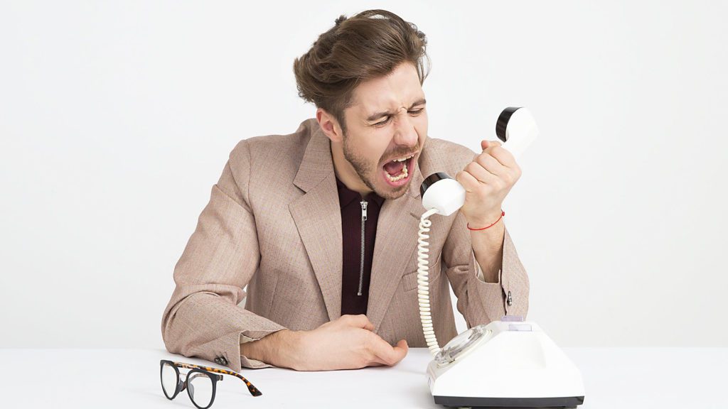 a man yelling at a telephone