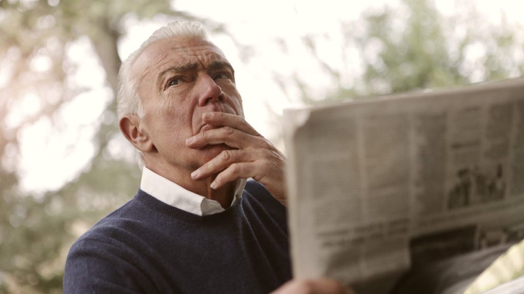 a man holding a newspaper