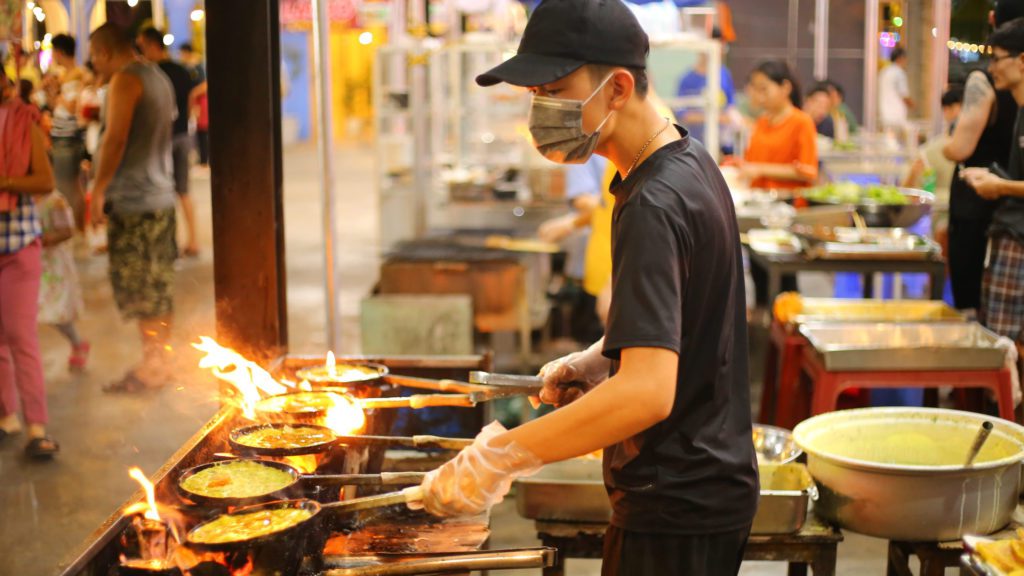 a man cooking food in a kitchen