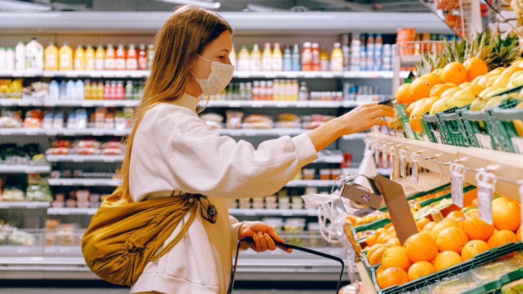 a woman wearing a face mask in a grocery store