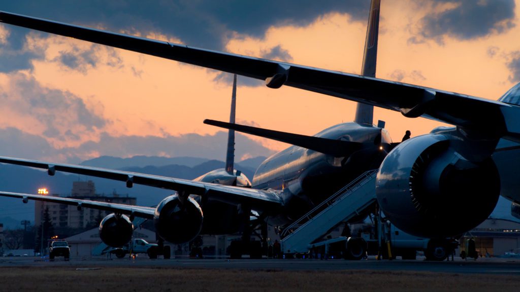 a group of airplanes parked on a runway