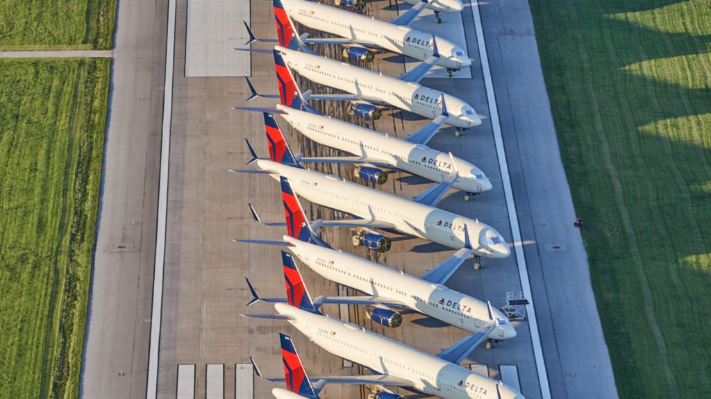 a row of airplanes parked on a runway