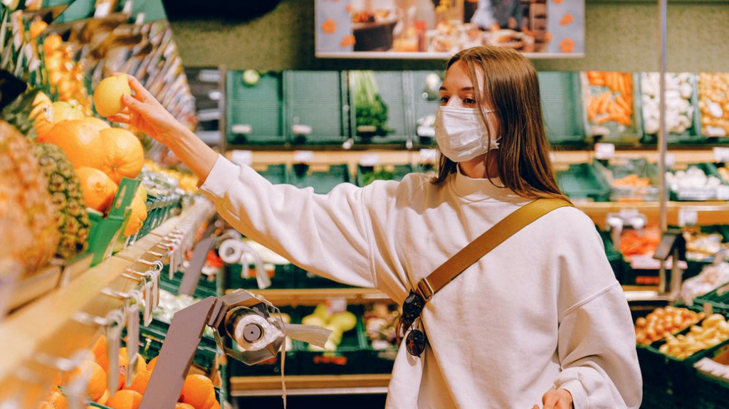 a woman wearing a face mask in a grocery store