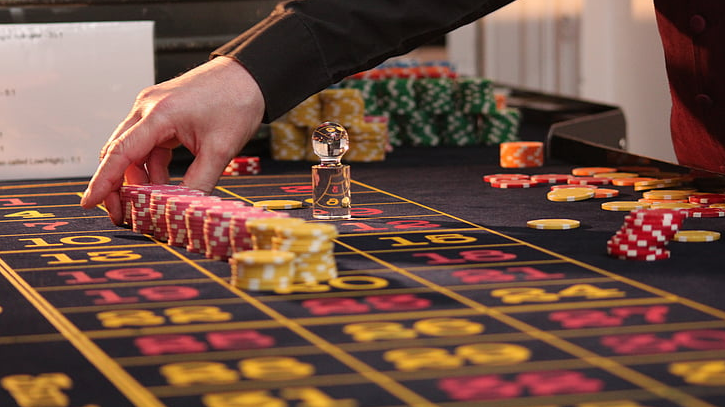 a hand reaching for a casino chips