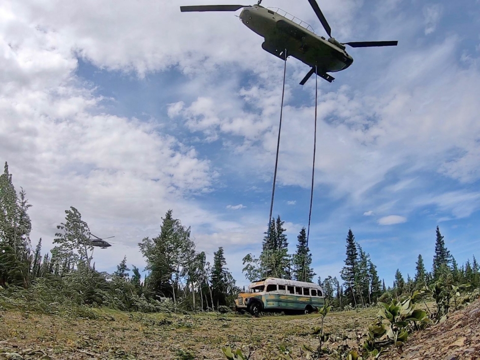 a helicopter flying over a bus