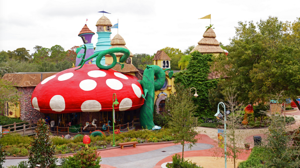 a building with a large mushroom and a large green snake