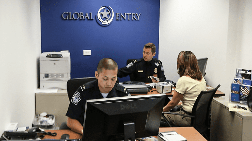 a group of people in a room with a police officer