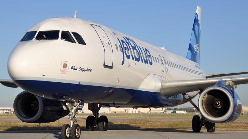a jet blue airplane on the runway