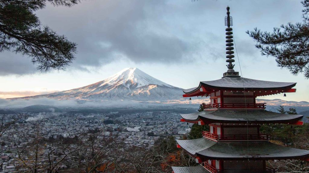 a pagoda with Mount Fuji in the background