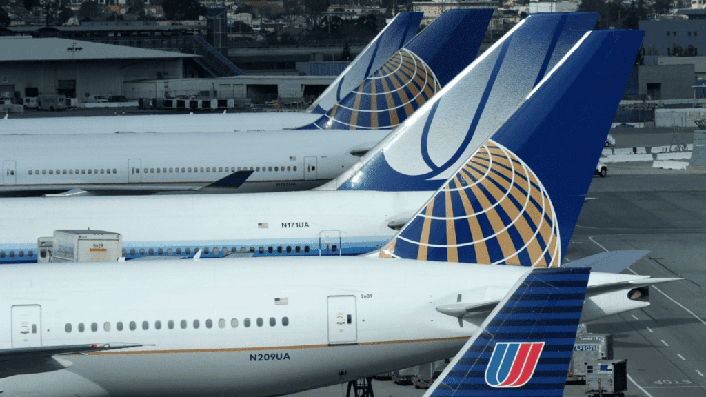 a group of airplanes parked at an airport