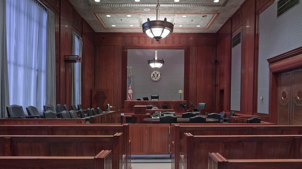 a courtroom with a flag from the ceiling