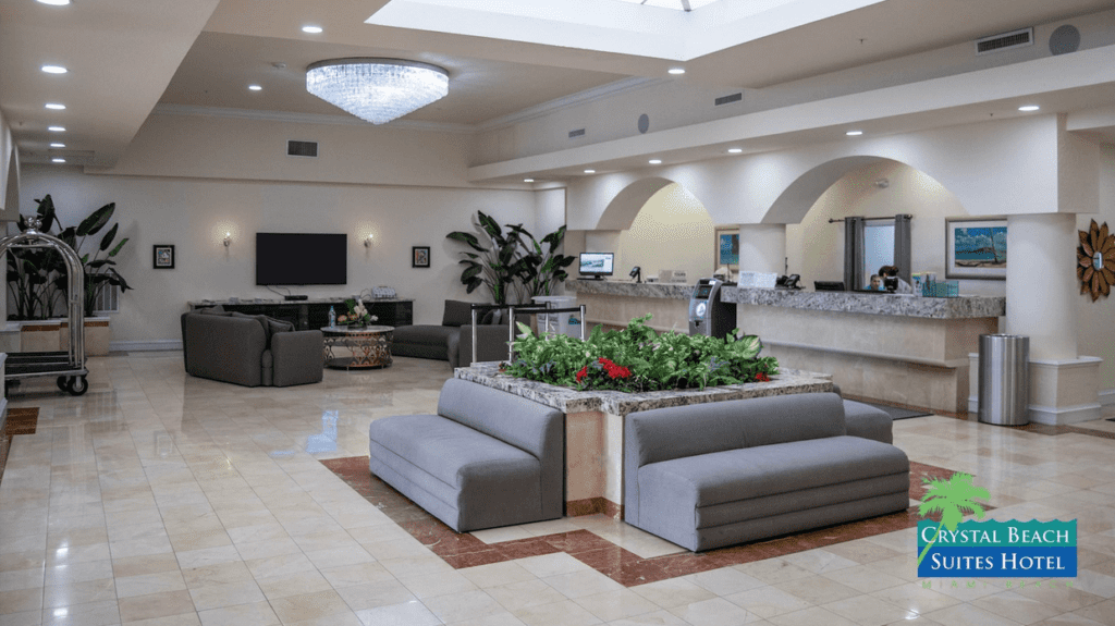 a lobby with couches and a planter