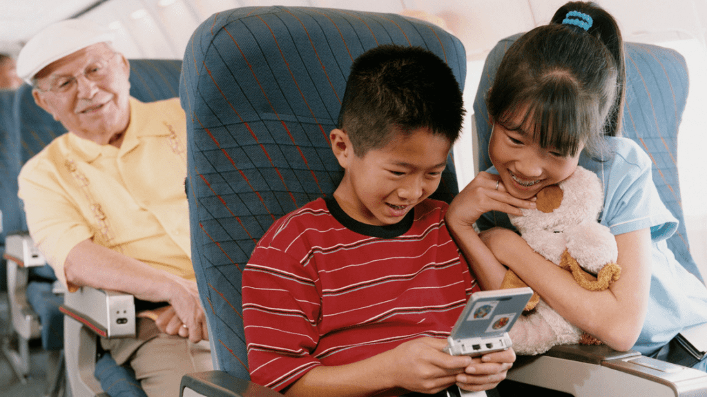 a boy and girl looking at a phone